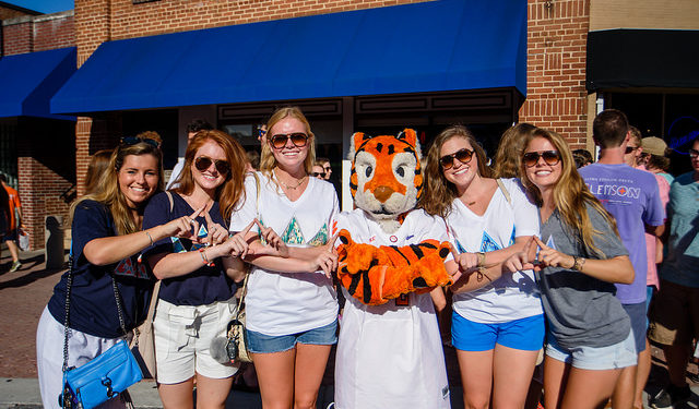 group of five students at the 2017 welcome back festival posing with the clemson tiger mascot
