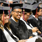 Students at graduation wearing cap and gown
