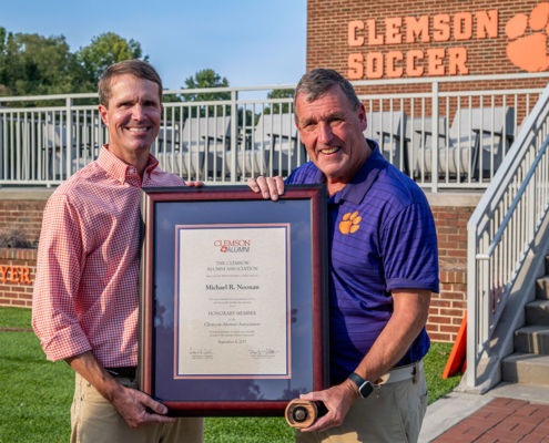 Wil Brasington presents the Honorary Alumnus designation to Clemson's head soccer coach, Mike Noonan.