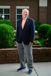 A photo of Hack Trammell standing in a courtyard