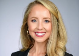Kayley Seawright smiling on gray background